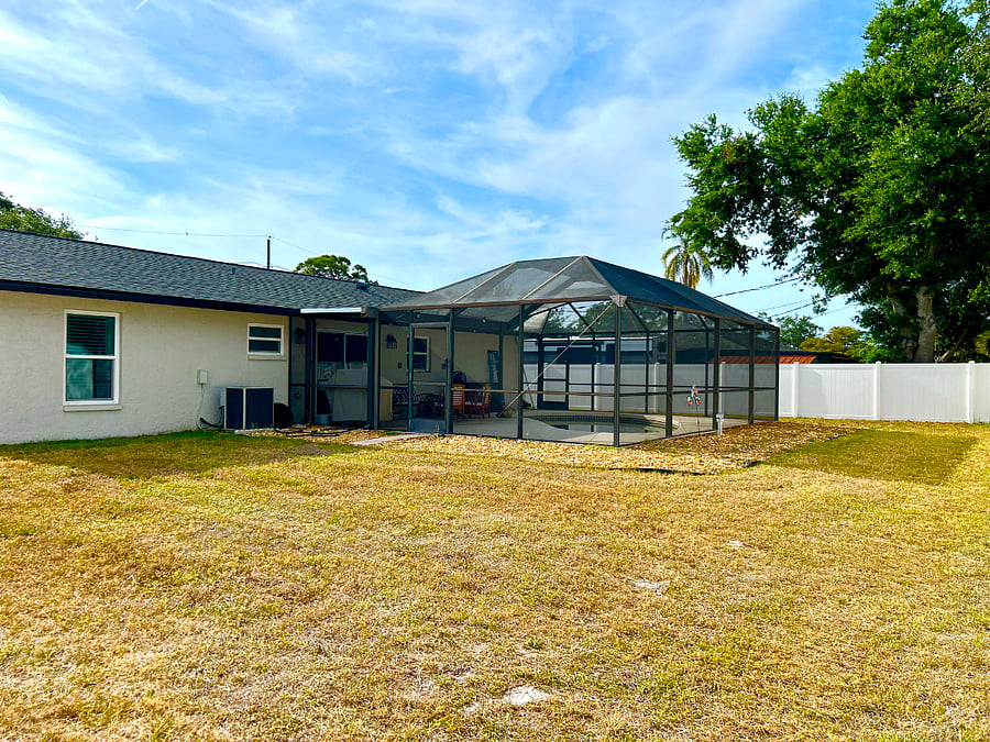 Fully fenced yard with gas grill ideal for pets or unwinding outdoors.