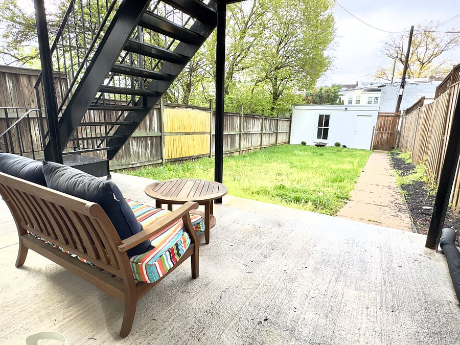 Outdoor seating and large backyard with garage access for bike storage
