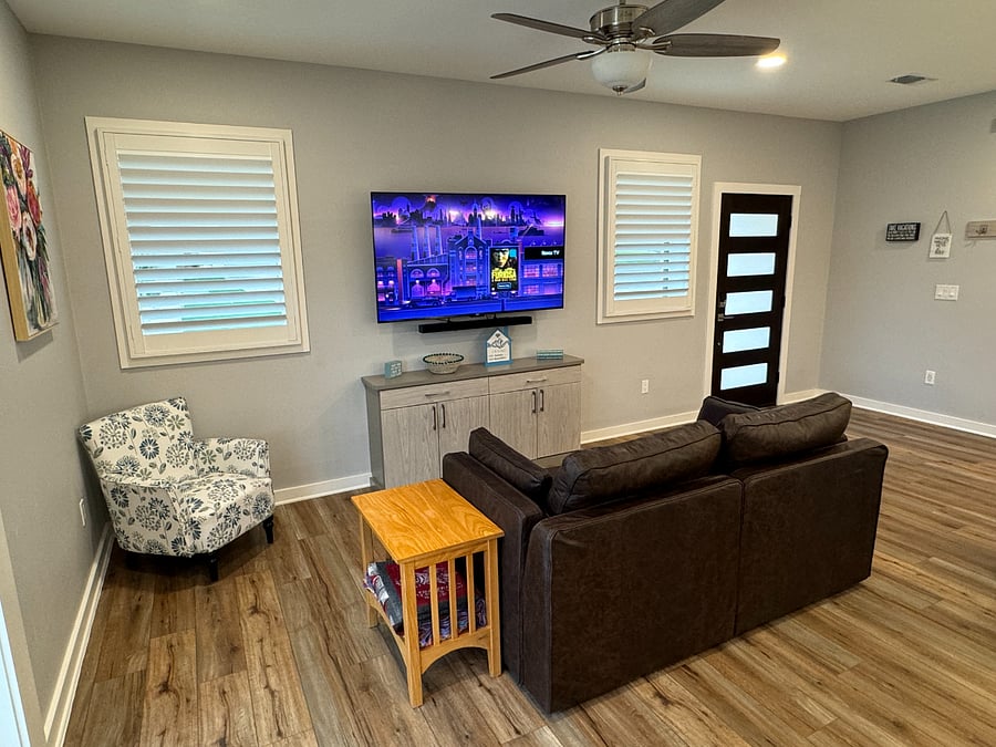 Living room with 65" Roku TV with Guest Mode - plus another convertible double bed via couch. NOT A PULLOUT. This one is comfortable.