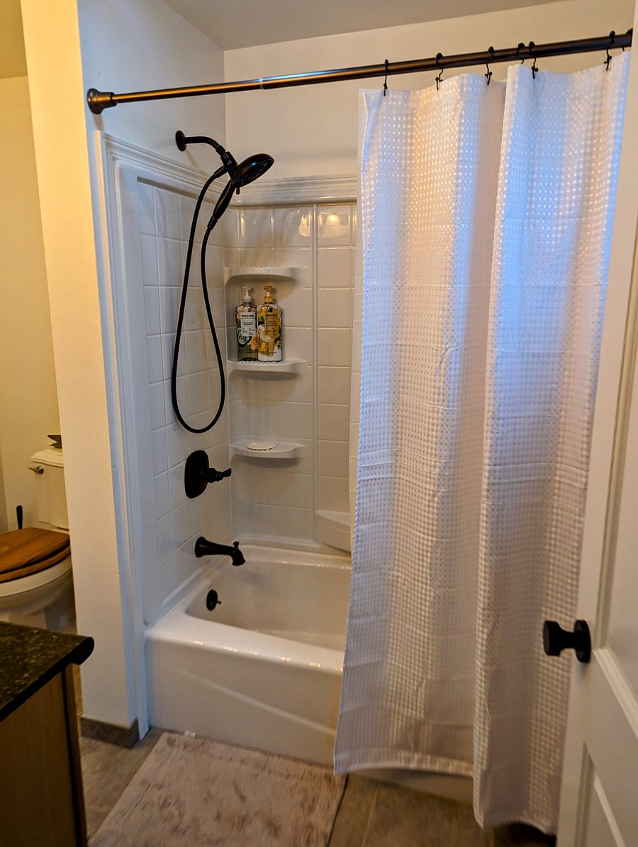 Large tub shower with both rain shower and handheld available