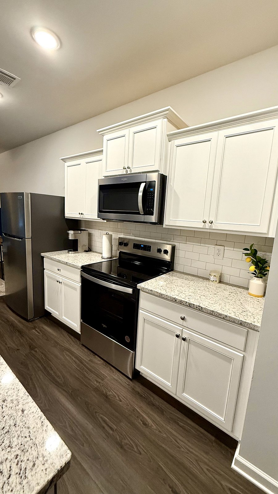 Fully stocked kitchen with plates, glasses, cookware, utensils, coffee pot, etc.