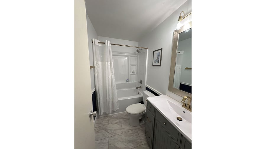 Fully renovated bathroom with new shower, vanity and updated floors.