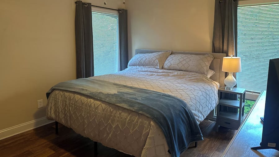 Primary Bedroom with King Bed, new Hybrid Mattress, and Blackout Curtains. 