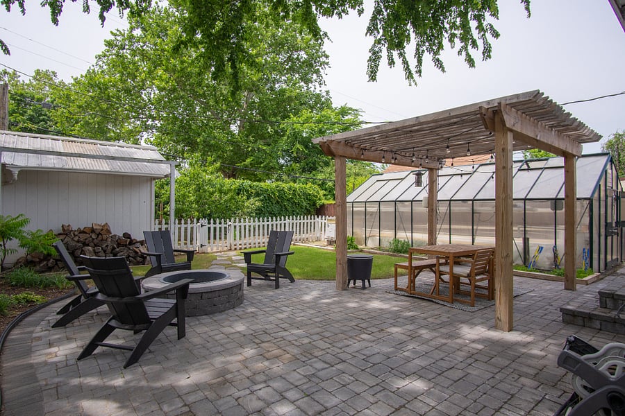 Backyard with fire pit area and back garden beds
