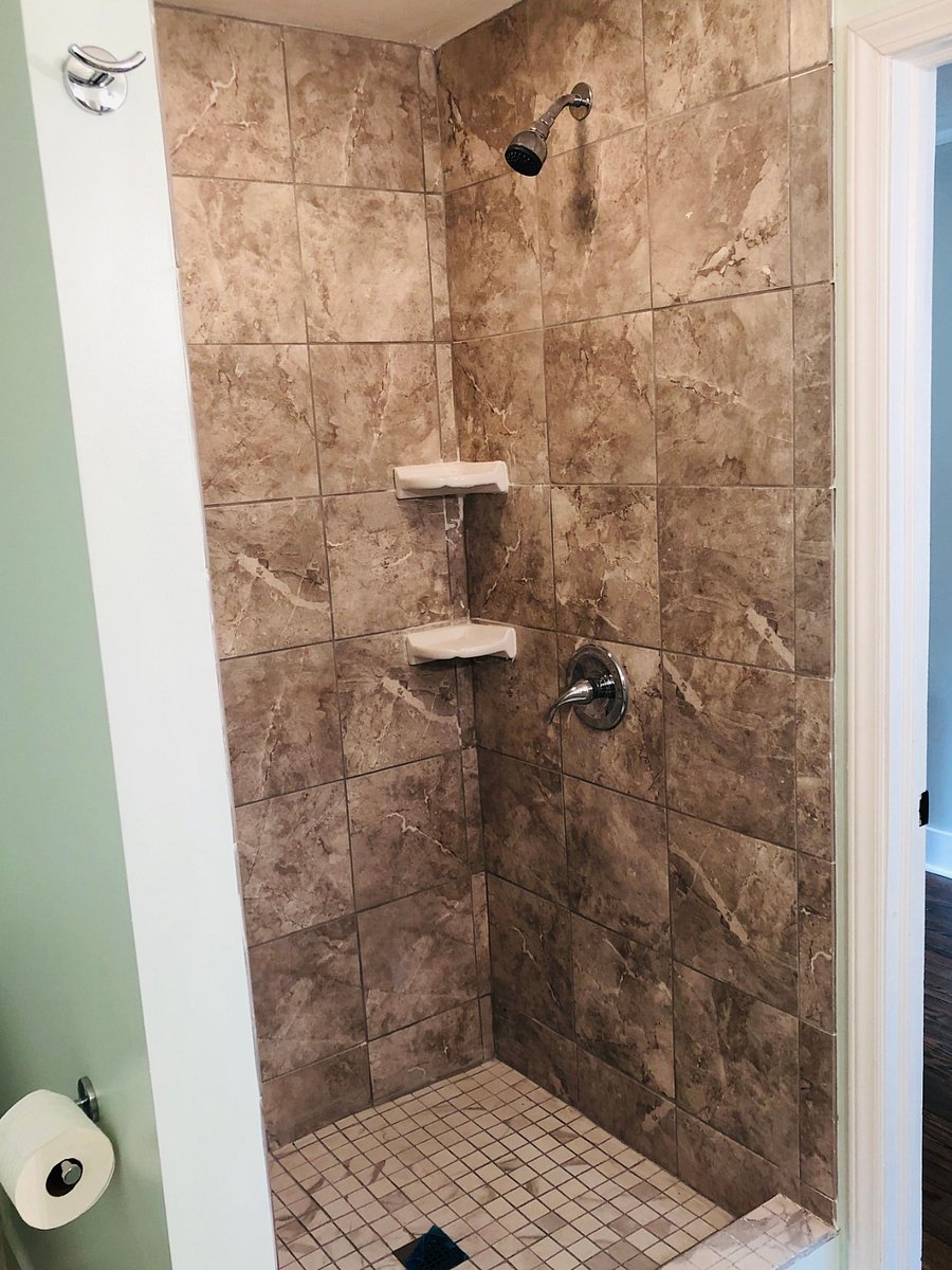 Walk-in tile shower in master bedroom.