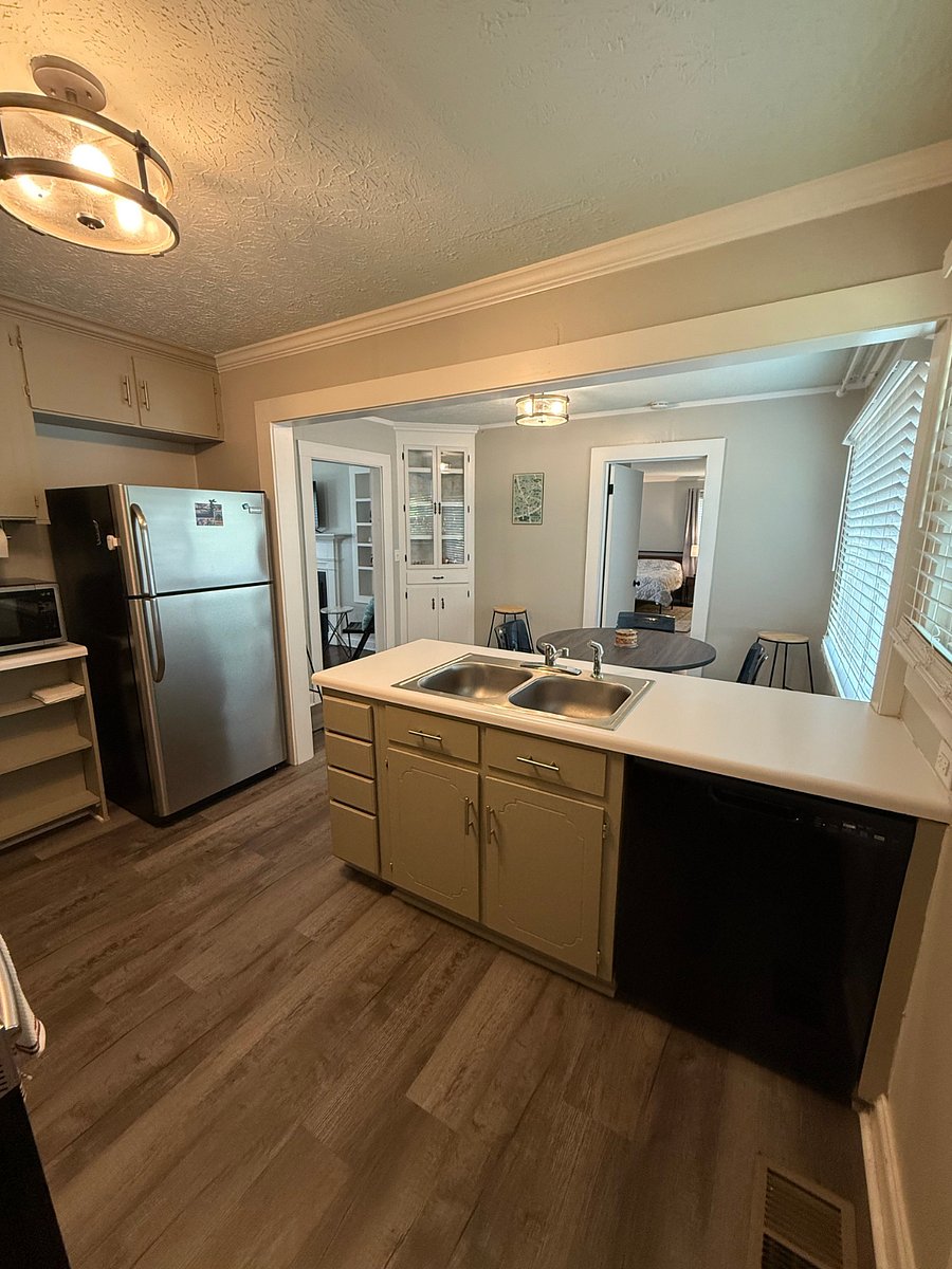 Kitchen with full size refrigerator, coffee maker, dishwasher, and oven.