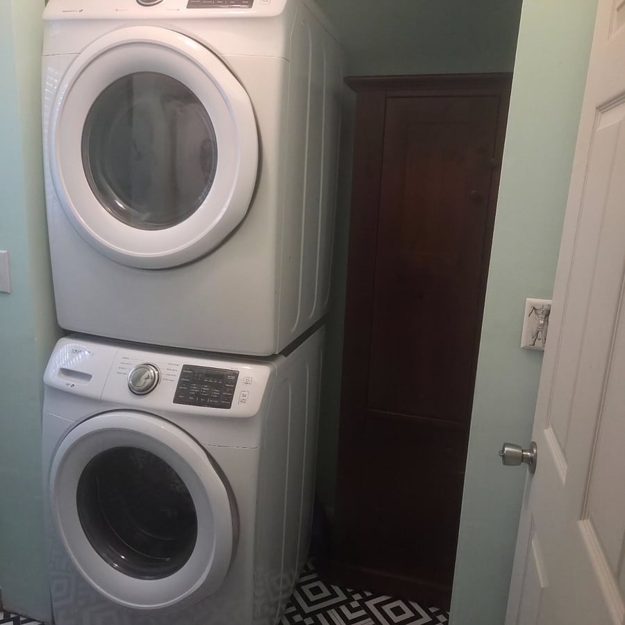 In unit front load washer and dryer. Linen closet with towels and extra sheets.