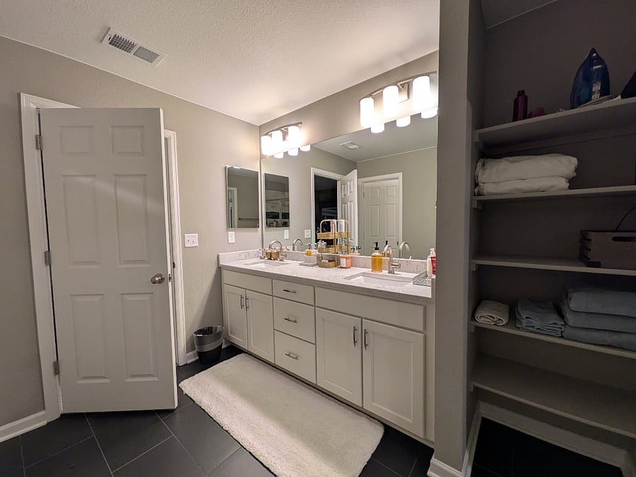 Primary bath: Jack & Jill sinks, storage shelves.