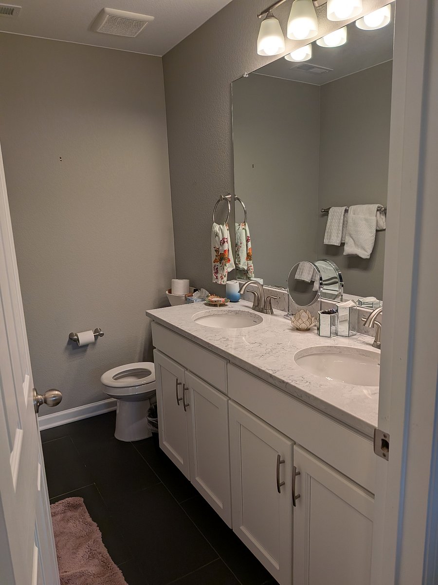 Upstairs bath has two sinks and a full-size bath tub.