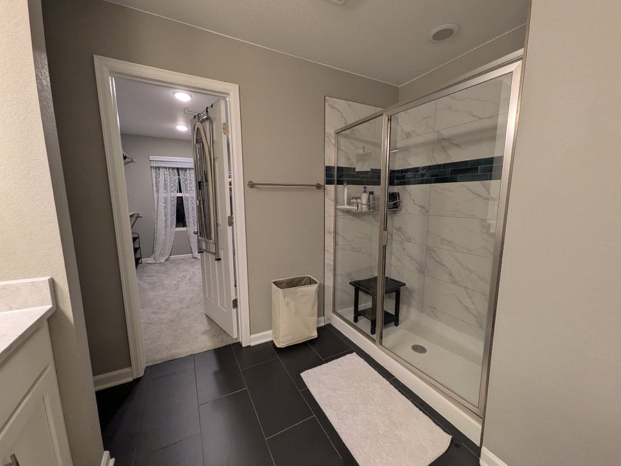 Primary bath to walk-in closet.