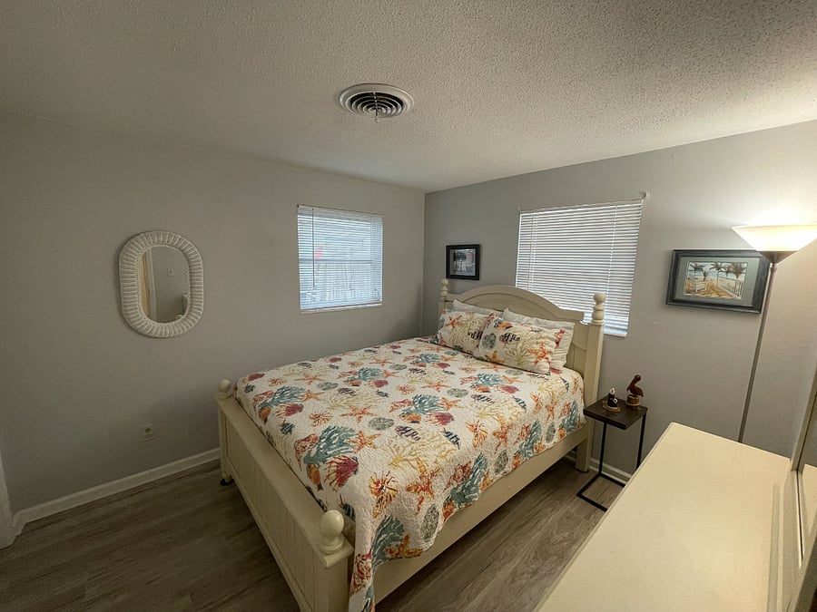 Queen sized bed with bureau and double closets.
