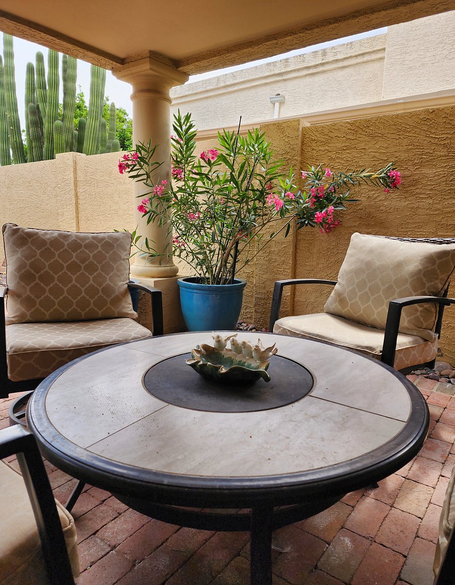Covered patio seating area with convertible fire pit