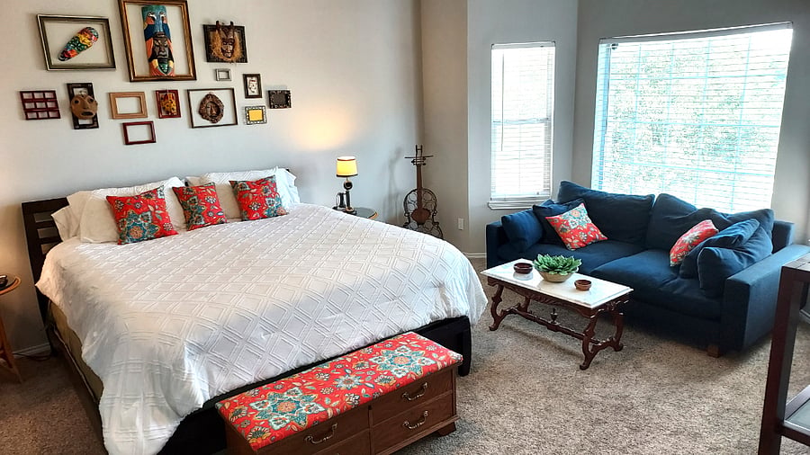 Very spacious master bedroom with comfy couch and TV