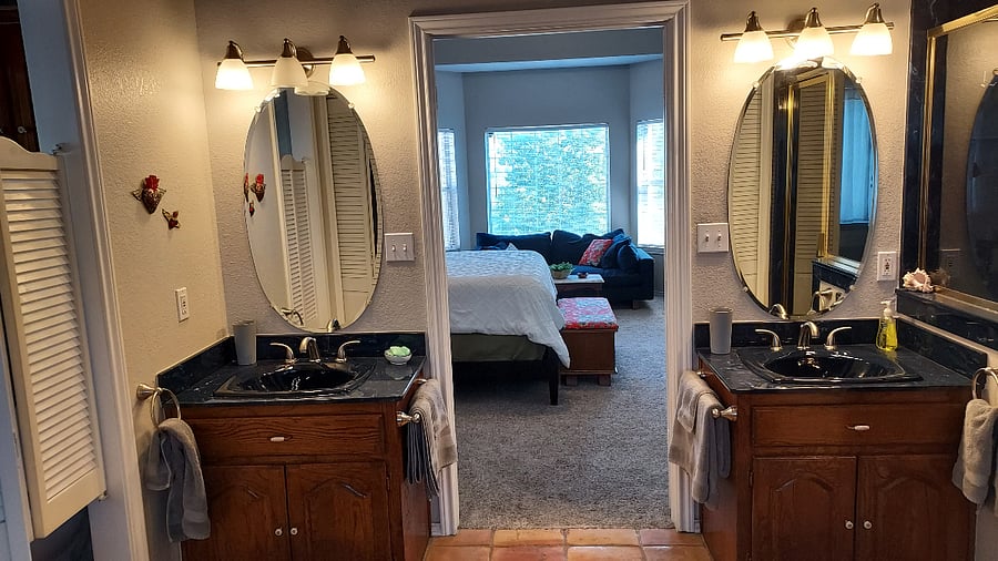Master ensuite bathroom with two sinks, two walk-in closets, shower & tub