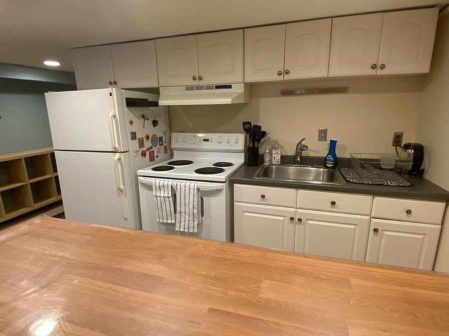 Full size stove, oven and fridge, along with blender and kettle, cooking utensils, full knife set, dining flatware, complete sets of glassware, plates, bowls, cups, glasses, mugs, placements, dish towels, potholders, mixing bowls, cutting boards, and baking pans.