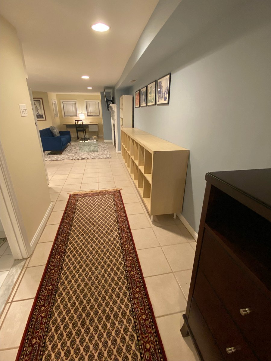 Hallway connecting main living area to bedroom, bathroom, and laundry room.