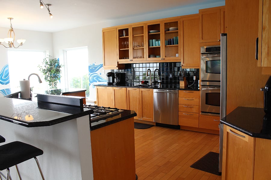 Kitchen includes two sinks, two dishwashers and two ovens and a gas countertop stove