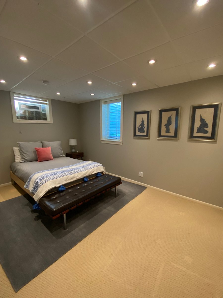 Lower level bedroom with plenty of closet storage space with a dresser.