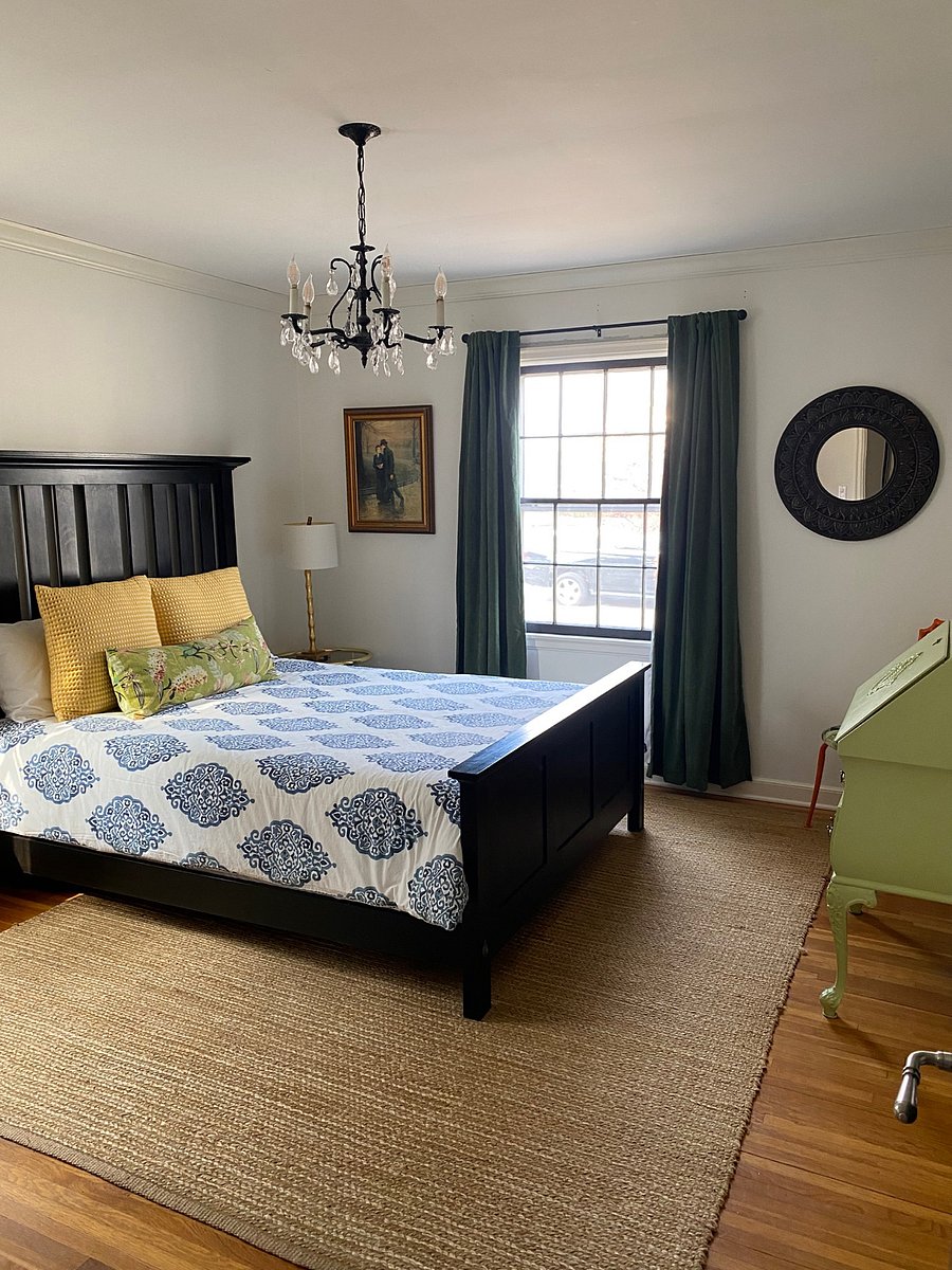 Another main floor bedroom with ample closet space, armoire and a secretary desk.