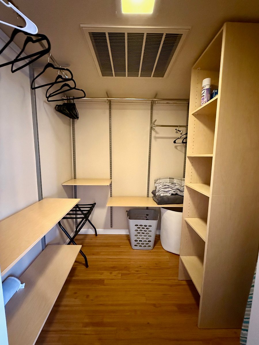 Tucked away on the loft level, this expansive walk-in closet offers both luxury and practicality. With ample hanging space, built-in shelving, its designed to keep everything organized and within reach.