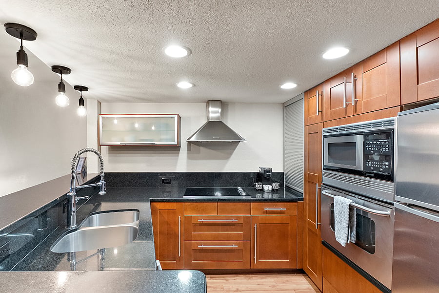 The kitchen boasts beautiful cabinetry that offers both function and elegance, while a spacious island provides additional prep space and a casual dining area.