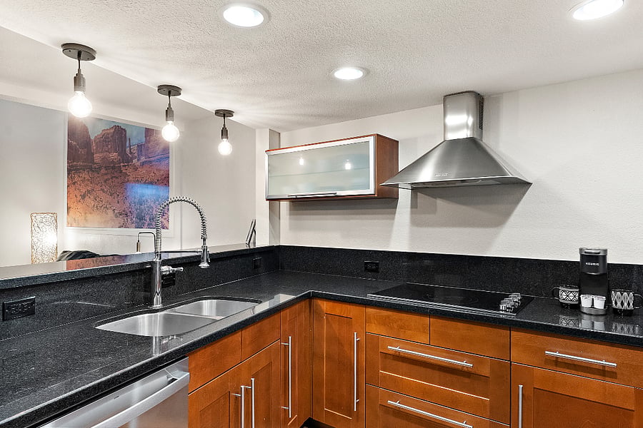 This kitchen is a chefs dream, featuring sleek countertops, high-end appliances, and abundant storage space. The open layout allows for effortless movement between the kitchen and living areas, making it ideal for both cooking and entertaining. Modern fixtures and finishes, including top-of-the-line stainless steel appliances, enhance the room's contemporary charm. Whether you're preparing a gourmet meal or enjoying a quick snack, this kitchen combines style and practicality to create the perfect culinary space.
