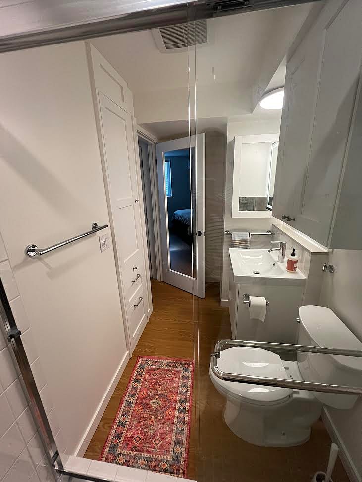 Bathroom has plenty of storage, heat fan, and lighted mirror.