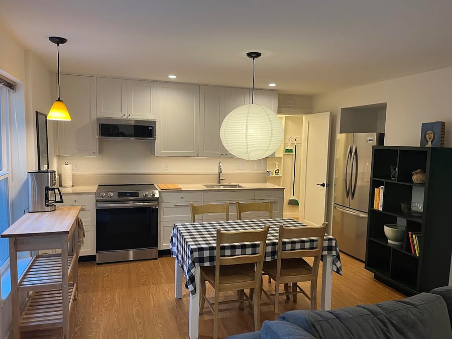 KitchenAid microwave, induction range, quartz countertops and full-size refrigerator