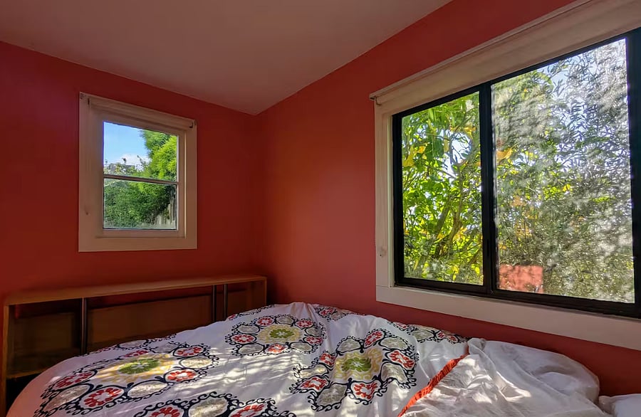 BEDROOM 3.  This bedroom has a door that opens to the beautiful patio and backyard.  Note: this bedroom is a pass through bedroom that can only be accessed by walking through BEDROOM 2.  The bedrooms are separated by a doorway with a heavy blackout curtain, NO DOOR.