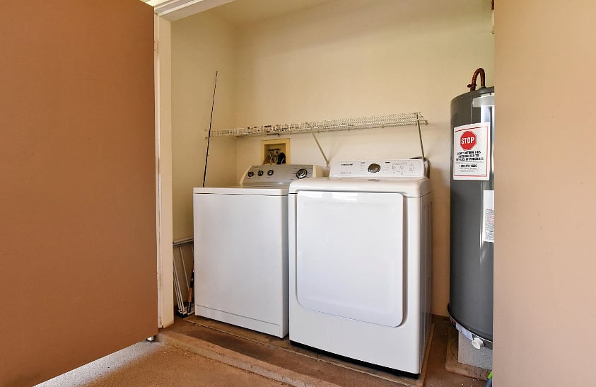Hidden in the lanai closet, a large washer and dryer with additional storage 