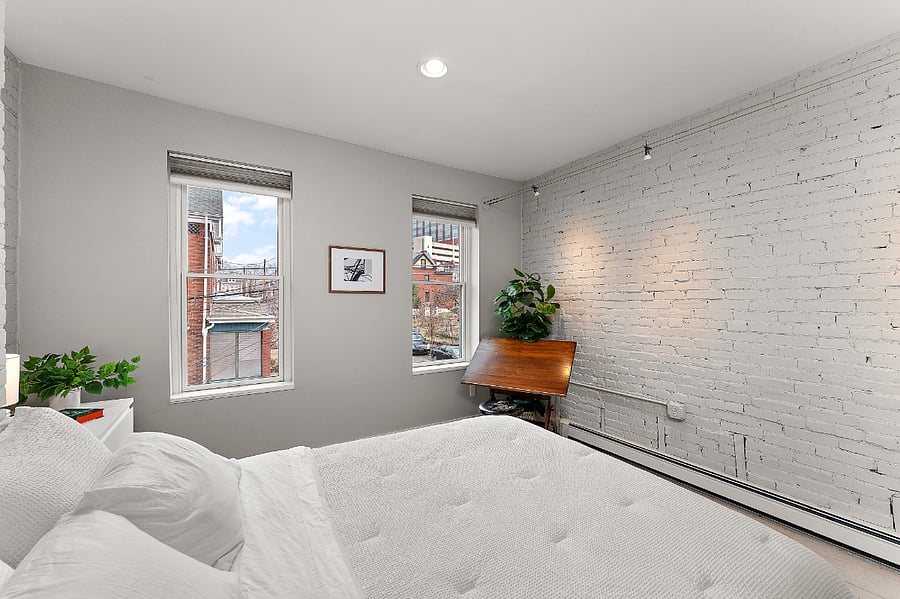The White Room: Second floor bedroom with queen size bed and antique drafting table. Pittsburgh themed art of Carrie Blast Furnace and former Civic Arena. View of Children's Hospital from window.