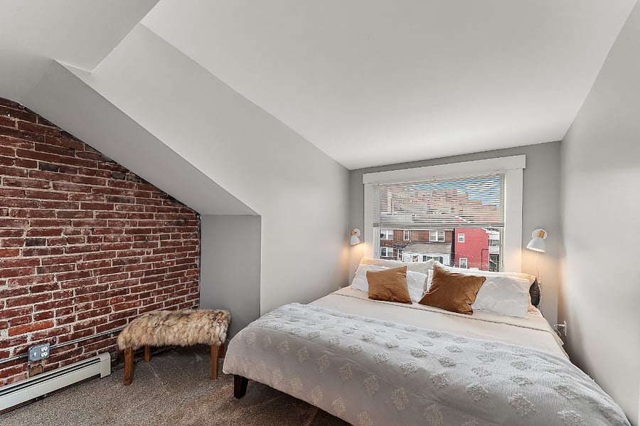 The Loft: third floor bedroom with king size bed and dedicated work area. Pittsburgh sports themed art and Kennywood prints.