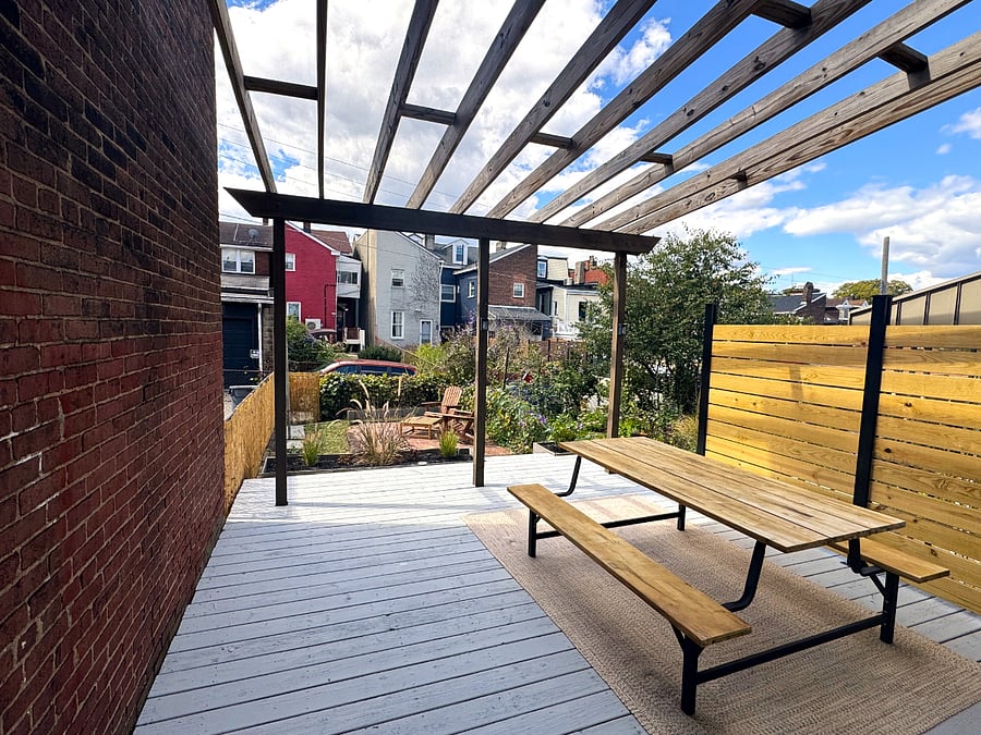 Enjoy your morning coffee in the newly updated back garden with fresh plantings, privacy fence, picnic table, and Adirondack chairs!