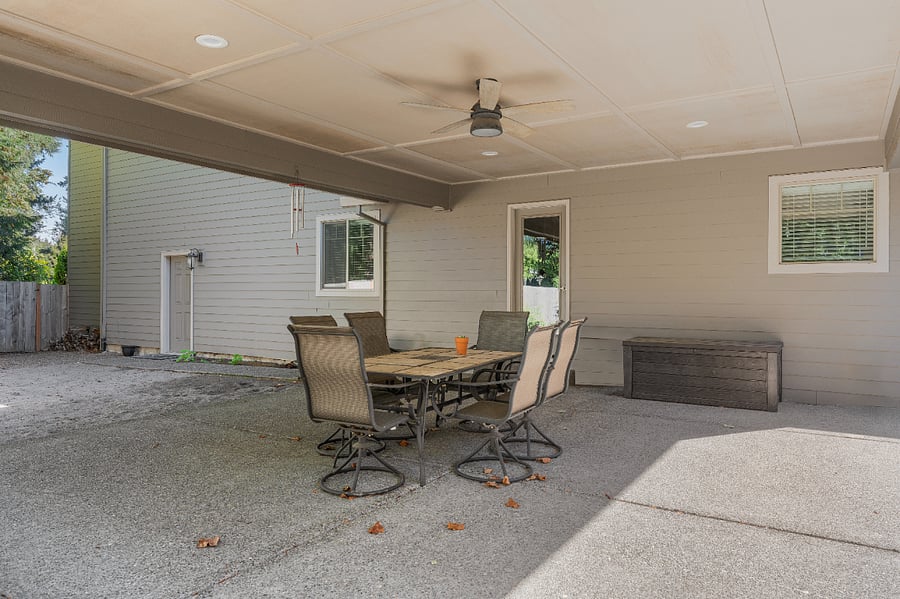 Enjoy covered backyard patio + dining space All season!