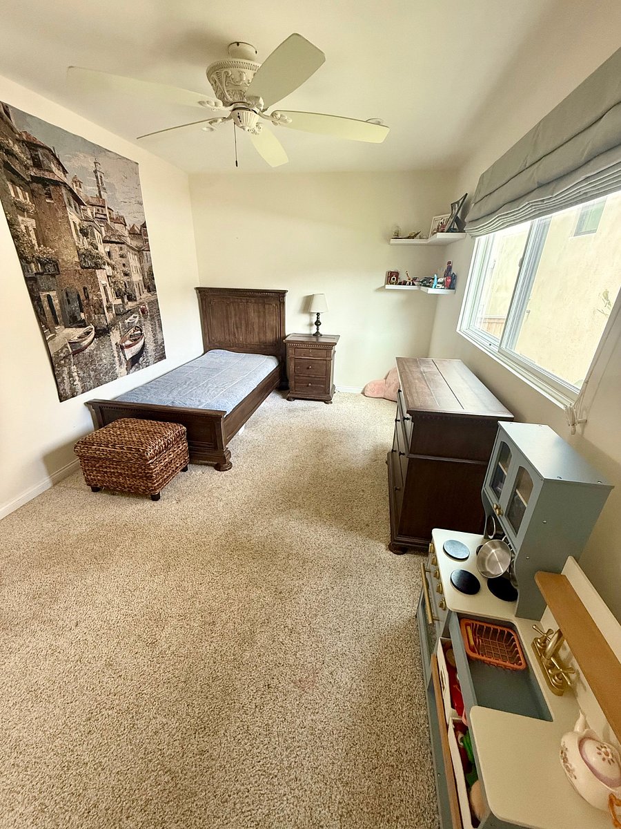 bedroom with twin bed and walk in closet
