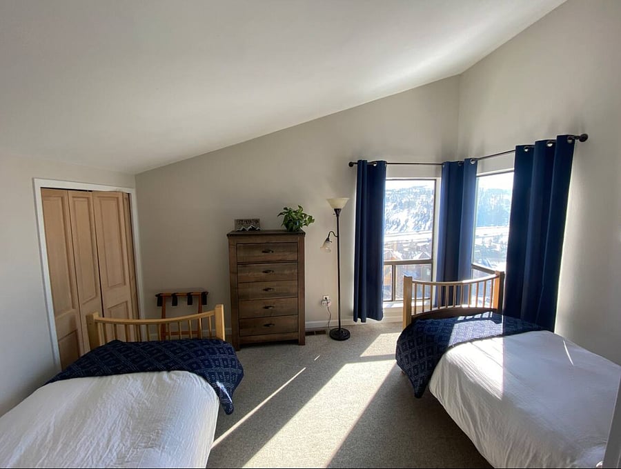 Two twin beds in bedroom in the loft. 