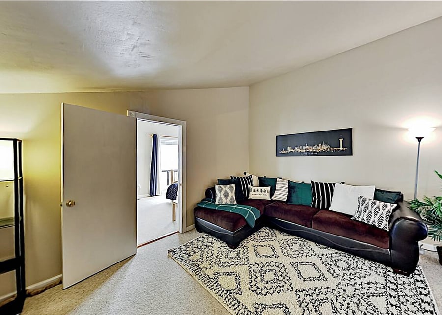 Additional sofa and lounging area in loft - with 3rd bedroom through the door. 