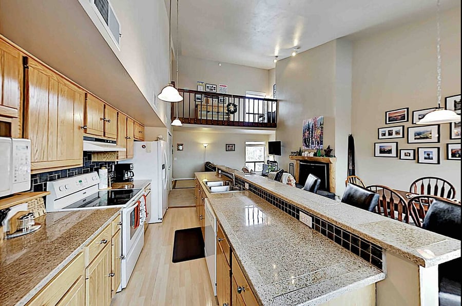 Open kitchen showing loft above.  