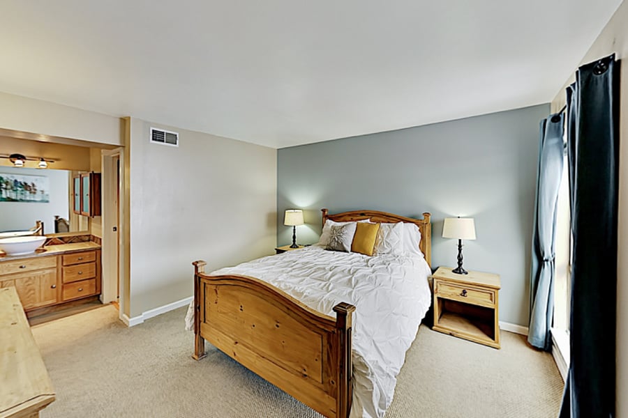 Master Bedroom with queen bed and sink area.  