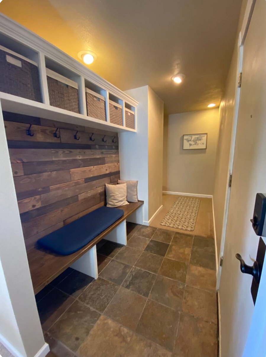Entryway with bench and plenty of space to hang jackets and store belongings.
