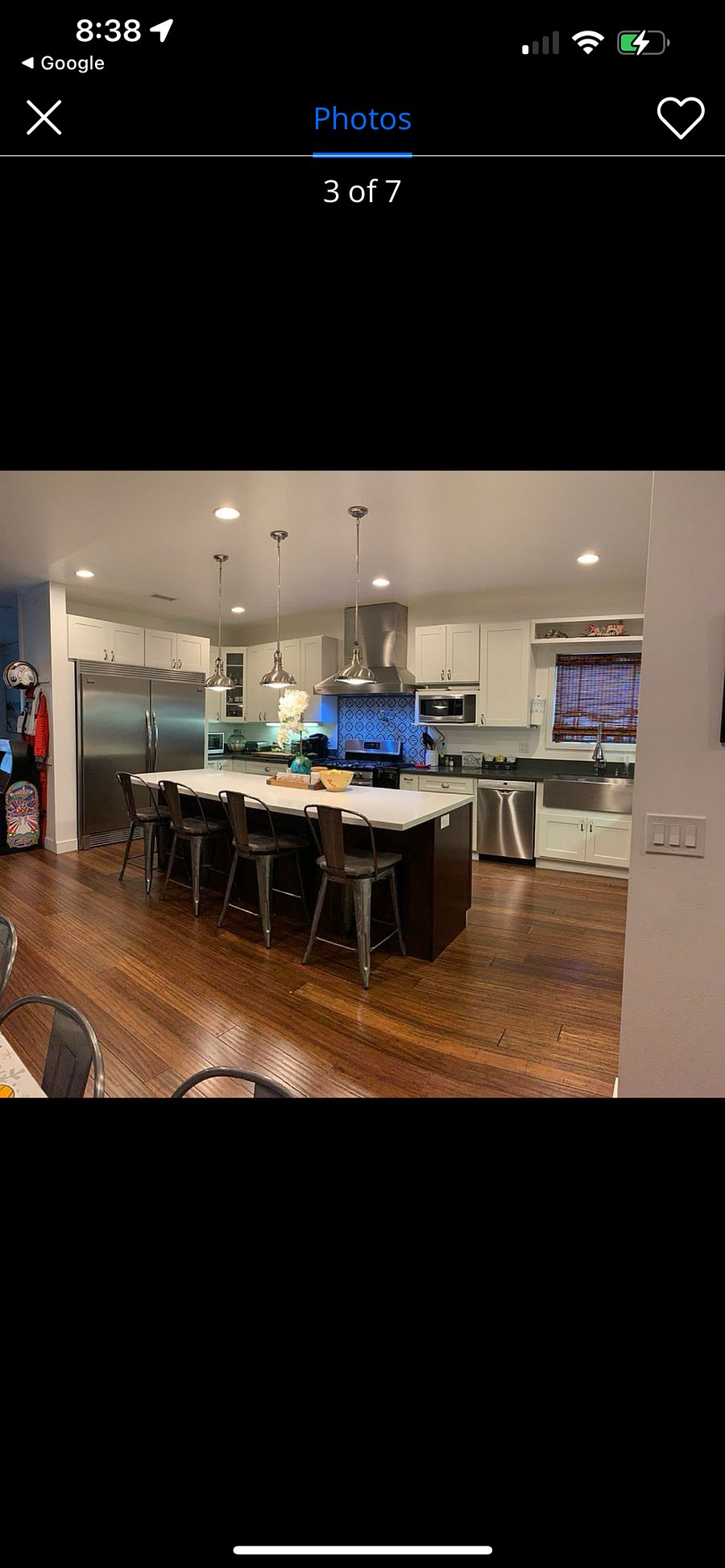 Large kitchen with island. Stainless steel appliances.