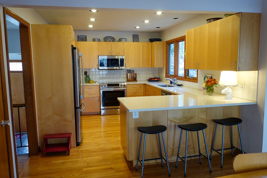 Kitchen with dishwasher, stove, microwave, and refrigerator, as well as the smaller appliances like a toaster, Ninja smoothie blender, and a Cuisinart.
