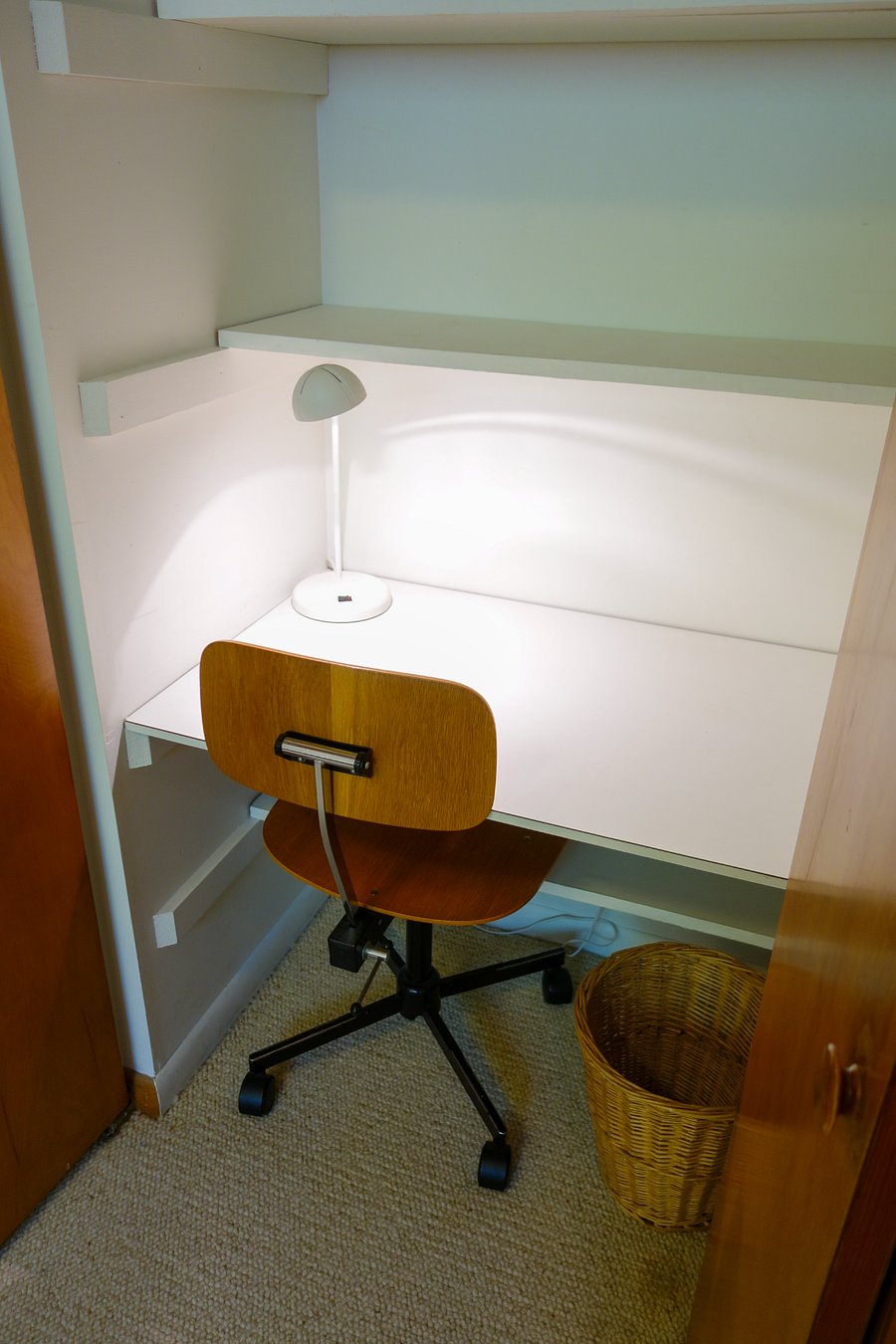 The desk comes with a desk lamp, desk chair, and a small trashcan.