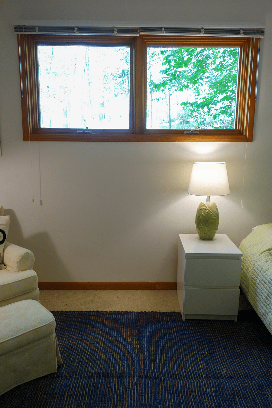 There are two large windows that look out across the yard, into the garden, and finally into the woods.