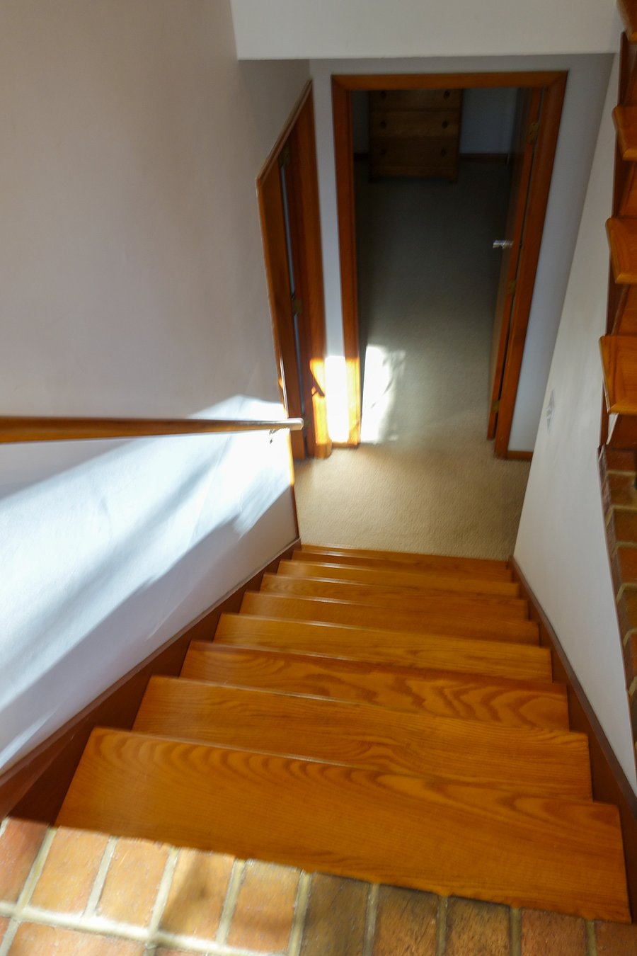 The second set of stairs leading to the lower story.