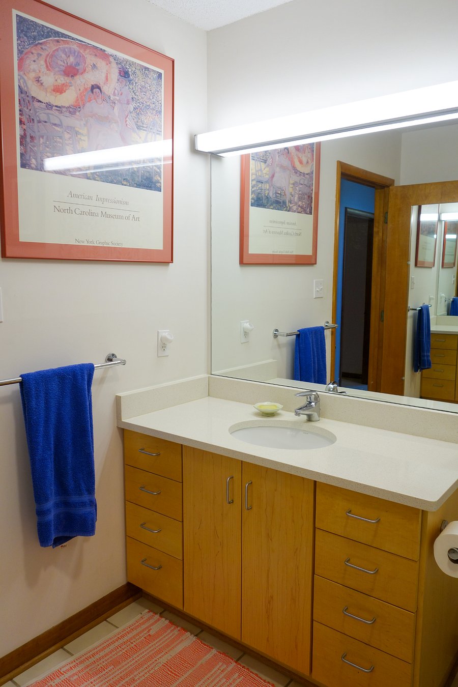 View of the vanity, large mirror, and some art work!