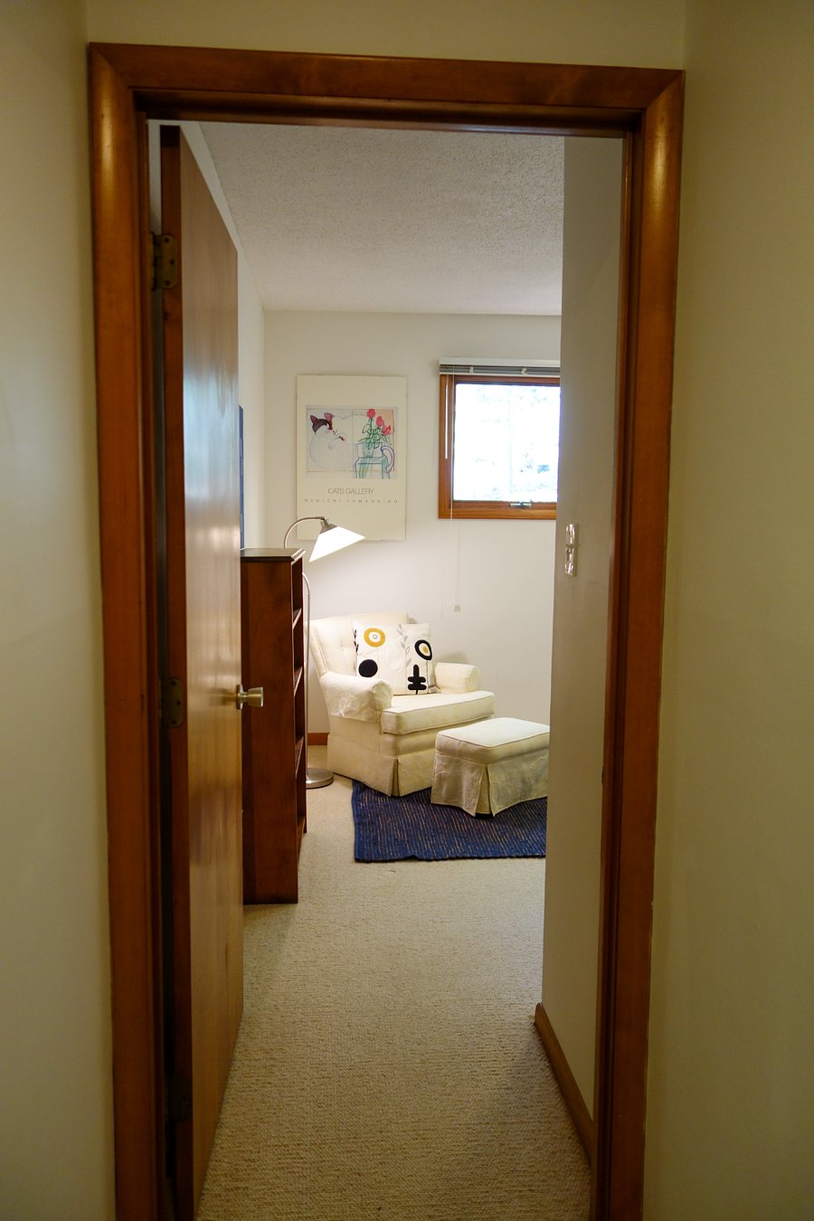 View from the hallway, past the bathroom, looking to the door and into the bedroom.