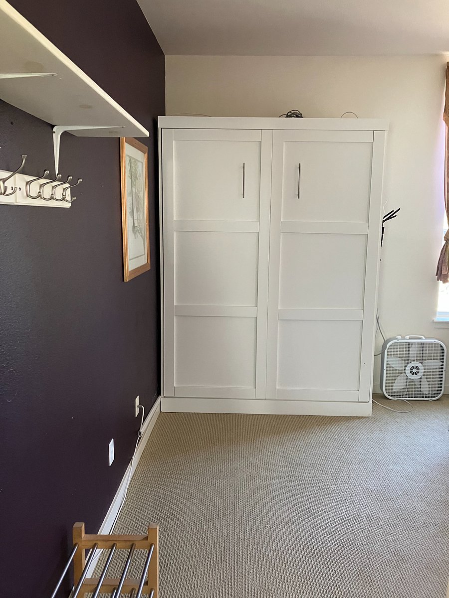 Third bedroom has Murphy bed, two work desks, office chair, box fan, and a extra storage above closet. 