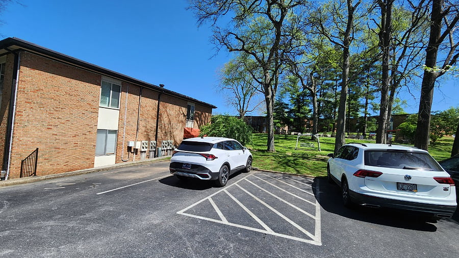 Additional view of parking lot, side of unit, and pool in background
