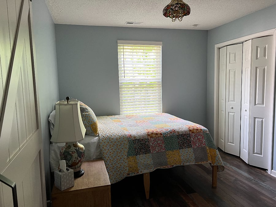 Double door closet in the bedroom with ample handing space and shelves.